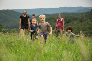 Une famille en train de randonnée dans un pré