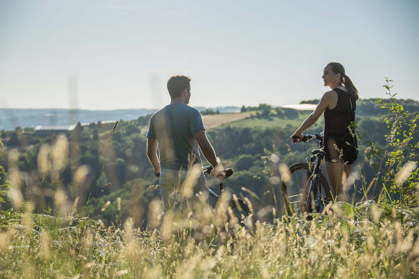 View of a couple mountain biking in the countryside