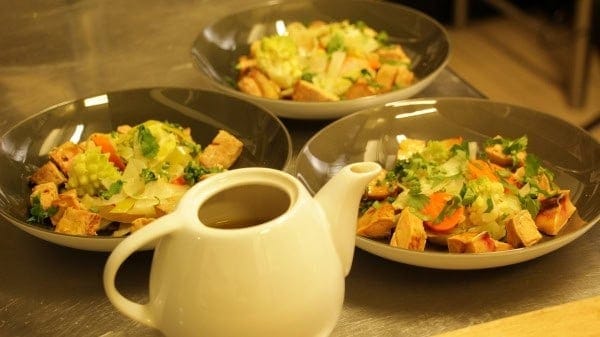Plates of foie gras and flavoured vegetable stock served in a jug