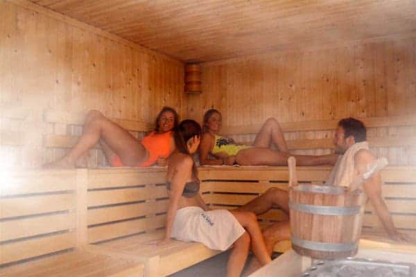 A group of friends chatting in a sauna