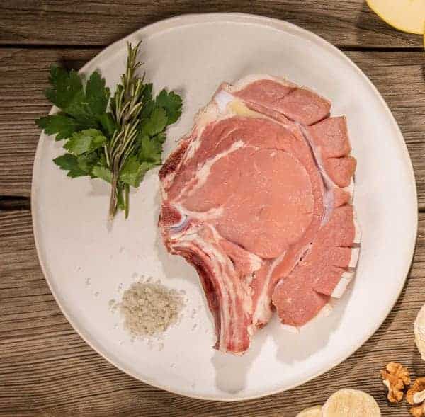 photo of a raw veal chop presented on a plate
